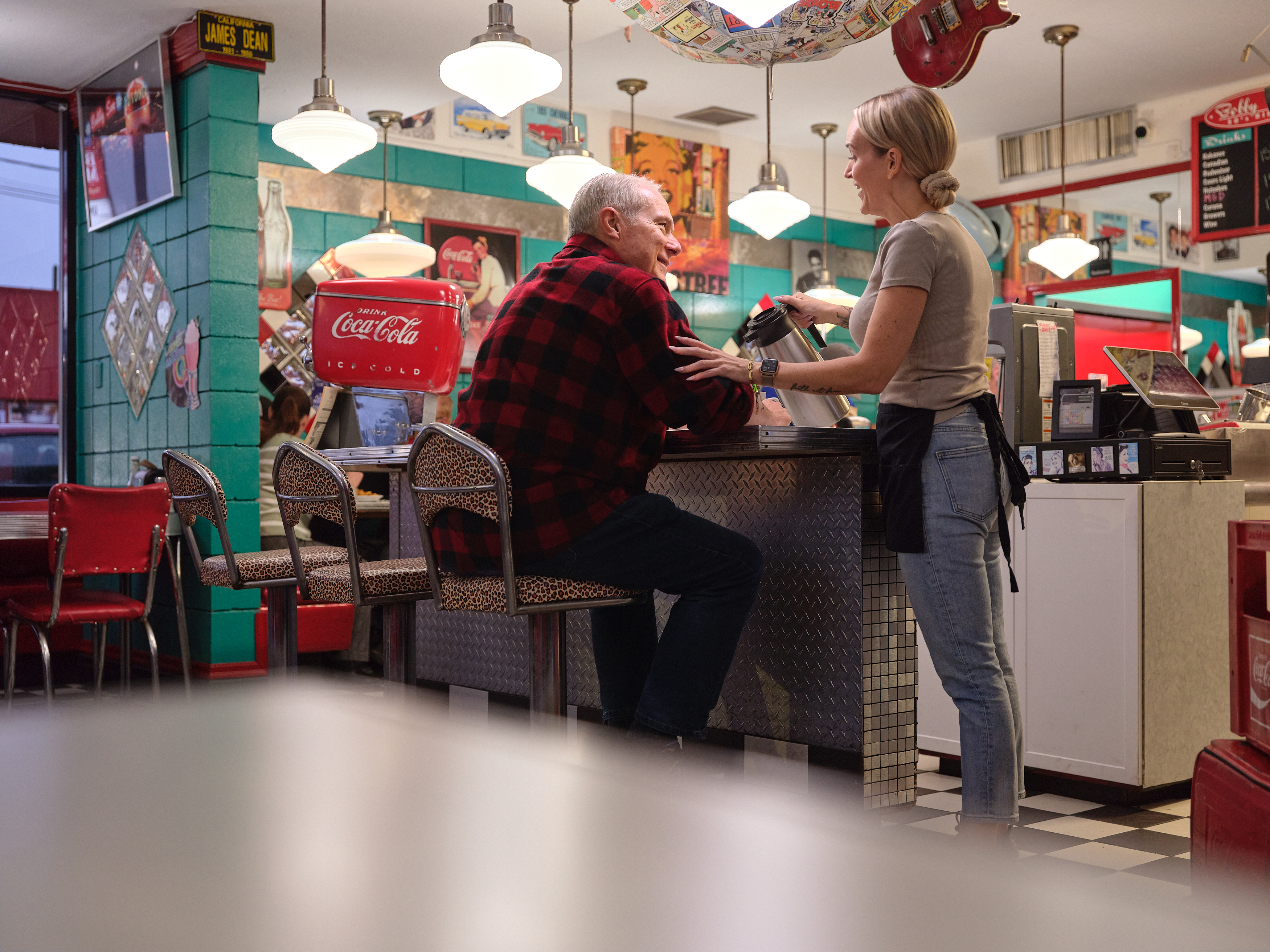Server Brittney pouring Fred a refill of coffee at Bobby Sox Diner in Maple Ridge.
