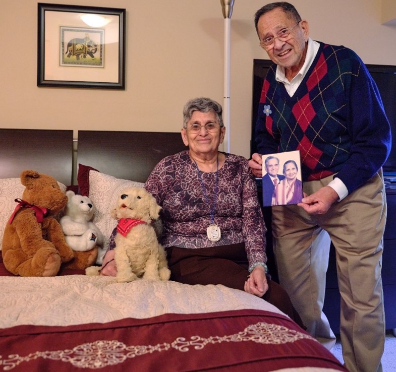 Ash, with his sister Malti, holding photo of their parents who took care of her for 64 years  