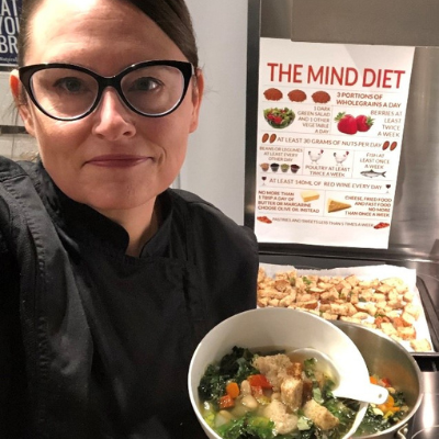 Chef liz holding a dish.